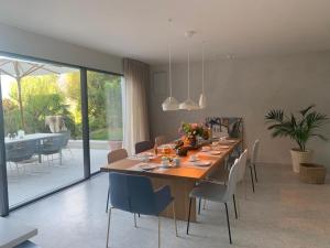 a dining room with a large wooden table and chairs at Villa Tschaupp in Tirolo