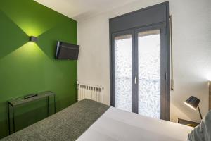 Voodi või voodid majutusasutuse Glaner Hotel Cafe toas