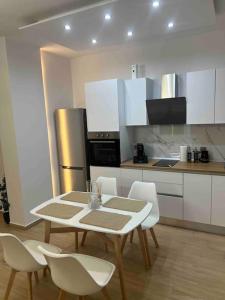 a kitchen with a table and chairs in a room at The Riverview in Florina