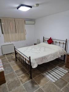 a bedroom with a bed with a white comforter at Aunt Maria's in Pano Lefkara