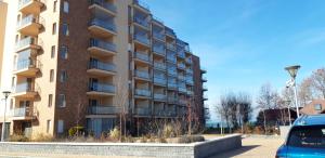 a tall building with a car parked in front of it at GalériusPrémium6 in Siófok