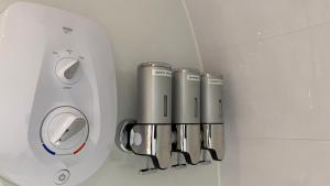a group of silver things hanging on a wall at The Sandy Pod in Stornoway