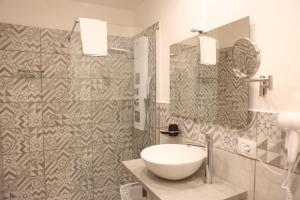 a bathroom with a sink and a mirror at Boutique Rooms B&B in Catania