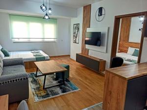 a living room with a couch and a table at Mango Apartments in Gevgelija