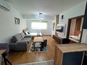 a living room with a couch and a table at Mango Apartments in Gevgelija
