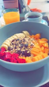 a bowl of food with fruit and vegetables on a table at White Seaview Residence in Klong Muang Beach