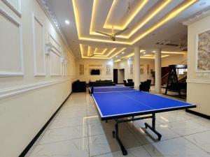 a room with a ping pong table in it at Motorway Majesty Lodges - Near Islamabad International Airport & Motorway in Islamabad