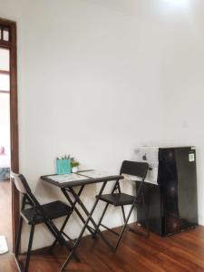 a table and chairs in a room with a kitchen at Wooden House Pool View by Malathi Villas in Ubud
