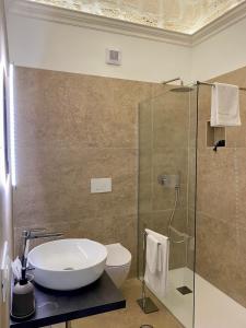 a bathroom with a sink and a shower at Bien-être Exclusive Apartment in Taranto