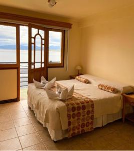 a bedroom with two beds with a view of the ocean at Balcones del Beagle Apart in Ushuaia