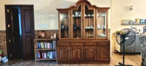 a large wooden cabinet in a room with a fan at Nature love Negombo in Kochchikade