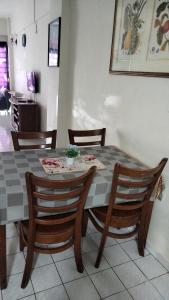 a dining room table and chairs in a room at Seaview beach Corus Paradise pd in Port Dickson