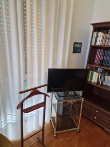 a room with a chair and a desk and a book shelf at B&B Cavaliere in Milan