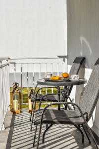 a patio table and chairs on a balcony at Anna and Jimmy's in Skiathos Town