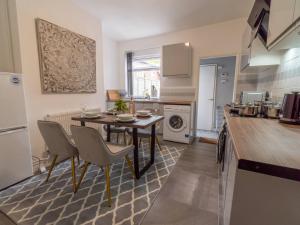 a kitchen with a table and chairs in a room at Pass the Keys Beautiful Home near City Centre in Nottingham