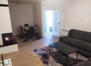 a living room with a couch and a table at Apartman Nona in Kupres