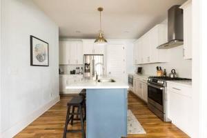 a kitchen with white cabinets and a counter top at The Lillian House - Steps to Five Points in Nashville