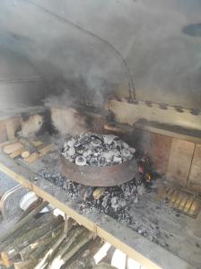 a grill with a bunch of food and smoke at Vikendica Ninic in Laktaši