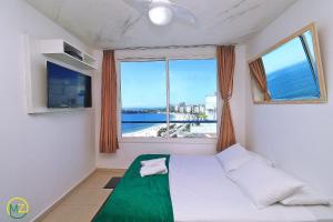 a bedroom with a bed with a view of the ocean at Oceanfront penthouse with private pool Copacabana in Rio de Janeiro