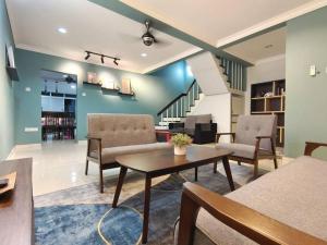 - un salon avec une table et des chaises ainsi qu'un escalier dans l'établissement Farrelhome langkawi affordable & comfortable house, à Kuah