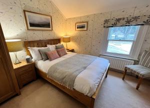 Ein Bett oder Betten in einem Zimmer der Unterkunft Ravenstone Lodge Country House Hotel