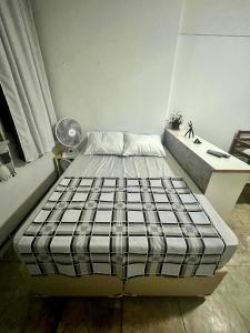 a small bedroom with a bed and a desk at Studio no Largo da Carioca - Rio de Janeiro in Rio de Janeiro