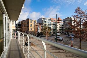 a balcony with a view of a city with buildings at ELPASO 0101 - Prachtig appartement voor 6 pers in De Panne