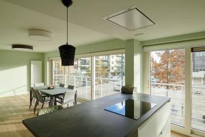a dining room with a table and chairs and a large window at ELPASO 0101 - Prachtig appartement voor 6 pers in De Panne