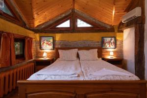 a bedroom with a bed in a room with wooden ceilings at Casa de Artes Guest House in Balchik +49 photos