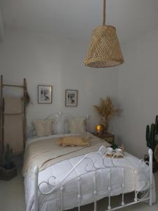 a white bed in a white bedroom with a lamp at Horizon View Arnados in Arnados