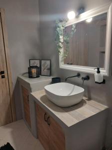 a bathroom with a white sink and a mirror at Horizon View Arnados in Arnados