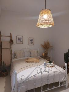 a bedroom with a white bed with a chandelier at Horizon View Arnados in Arnados