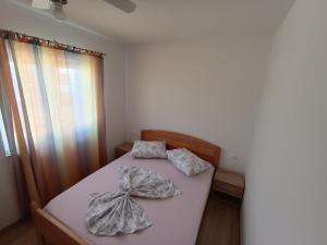a bedroom with a bed with two pillows on it at Apartments Solta in Nečujam +102 photos