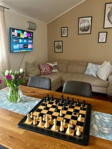 una sala de estar con un tablero de ajedrez sobre una mesa en Nido Appartamento, en Cavallino-Treporti