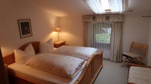une chambre avec un lit et une fenêtre dans l'établissement Ferienwohnung Zahnder inkl. Chiemgaukarte, à Ruhpolding