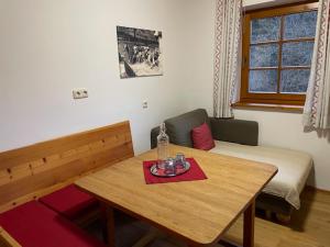 a small room with a table and a bed at Gasthof Thurnerhof in Feld am See