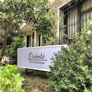 a sign in front of a building at Oriente Hostal in Talca