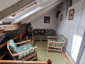 a living room with two chairs and a couch at El Callejo de Abiada in Abiada +34 photos