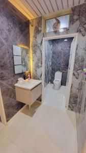 a bathroom with a sink and a toilet in it at شـاليــه غـيــم in Riyadh