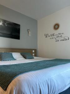- une chambre dotée d'un grand lit avec des draps bleus dans l'établissement Hotel La Voile, à Bormes-les-Mimosas