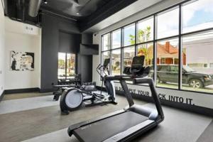 a gym with two exercise bikes and a treadmill at Downtown Dolly - Stylish Airy and Cozy in Nashville
