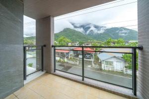 a balcony with a view of a mountain at 放慢3館, 近山右民宿 6-12人, 只接一組客人, 按人數開放房間 in Hualien City