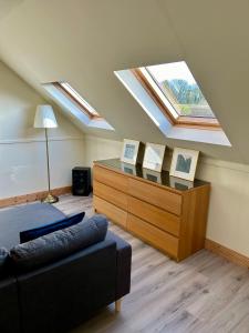 a attic room with a skylight and a bed and a dresser at The Loft @ Kildare Village in Kildare