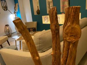 a living room with a chair and a table at Hotel La Voile in Bormes-les-Mimosas