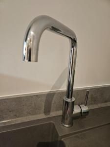 a kitchen sink with a chrome kitchen faucet at 2 Double Beds - 2 Single Beds in Manchester