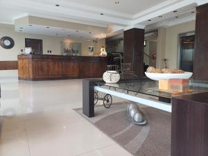 a lobby with a table with a bowl of food on it at Hotel Solar Norte in San Miguel de Tucumán