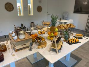 a table with a bunch of food on it at Hotel La Voile in Bormes-les-Mimosas