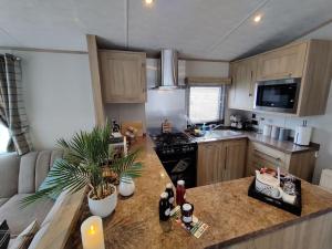 a kitchen with a island in a small kitchen at Forest Getaway, sleeps 6 at Bashley, leisure PASS included in New Milton