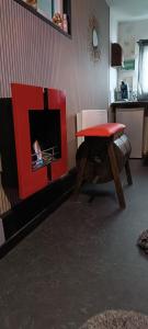 a living room with a fireplace and a red table at LOVE ROOM Cabane des charmes in Andernos-les-Bains