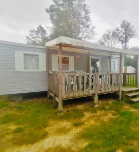 Ce mobile home dispose d'une terrasse couverte. dans l'établissement Mobil home 6 personnes - puy du fou, à La Boissière-de-Montaigu